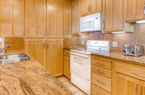 Brockway Condo | Lakeside condo with water views, private beach, dock, buoy, and wood fireplace