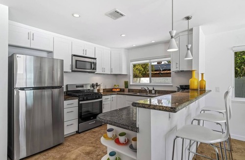 Desert Park Estates House | Palm Paradise offers a private 3BR retreat with a saltwater pool, fire pit, BBQ, and mountain views. Just minutes from downtown, this stylish getaway is perfect for families or friends seeking relaxation and Palm Springs charm.