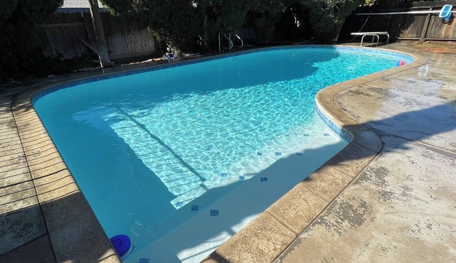 Beautiful Home in quiet neighborhood with a pool and close to stores & highways.